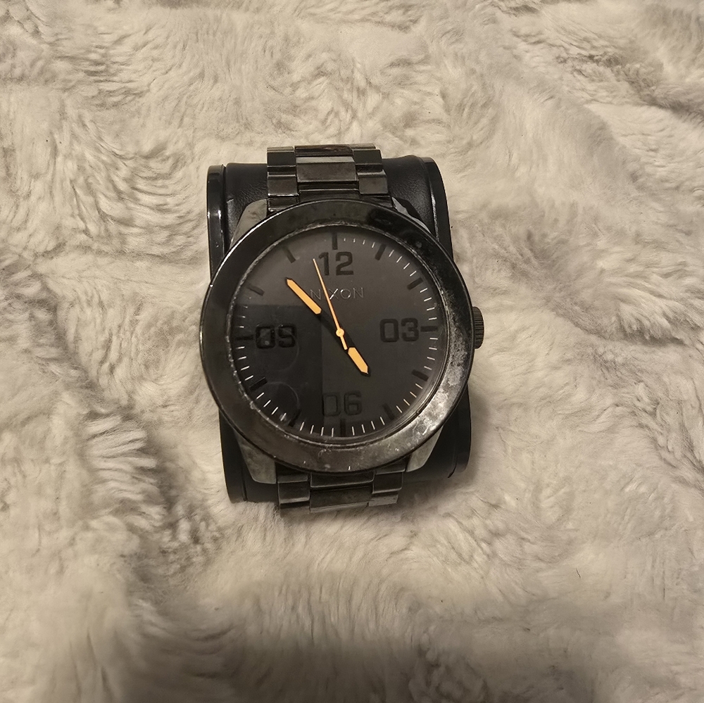 Nixon Black and Silver Watch with Orange Hands